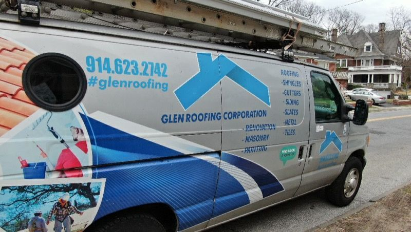 A glen roofing van is parked on the side of the road.